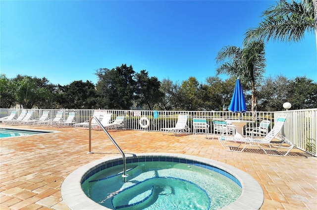 view of pool featuring a hot tub