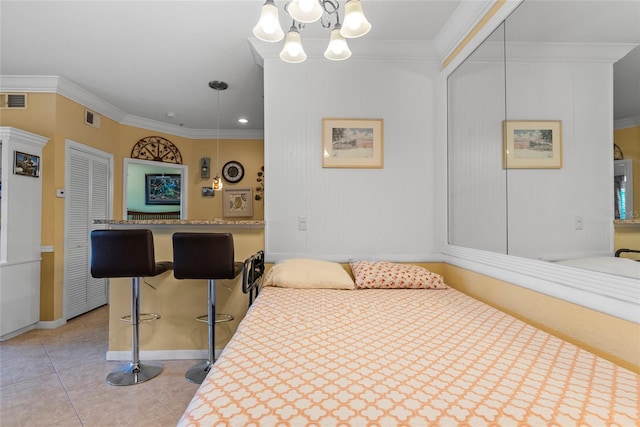 bedroom featuring light tile patterned floors, an inviting chandelier, and ornamental molding