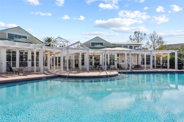 view of pool with a pergola and a patio