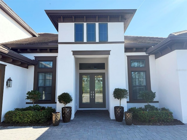 5305 Brookgrove Dr, Sarasota, FL 34238 - property entrance featuring french doors and stucco siding