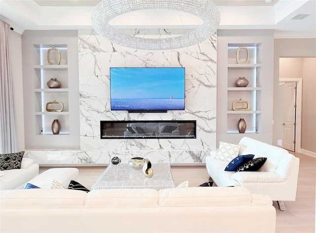 5305 Brookgrove Dr, Sarasota, FL 34238 - living room with crown molding, built in shelves, and a fireplace