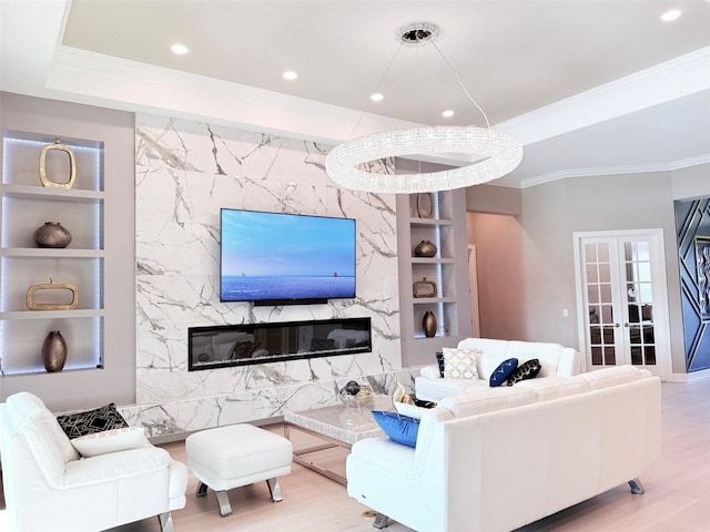 5305 Brookgrove Dr, Sarasota, FL 34238 - living area featuring built in shelves, a tray ceiling, and wood finished floors