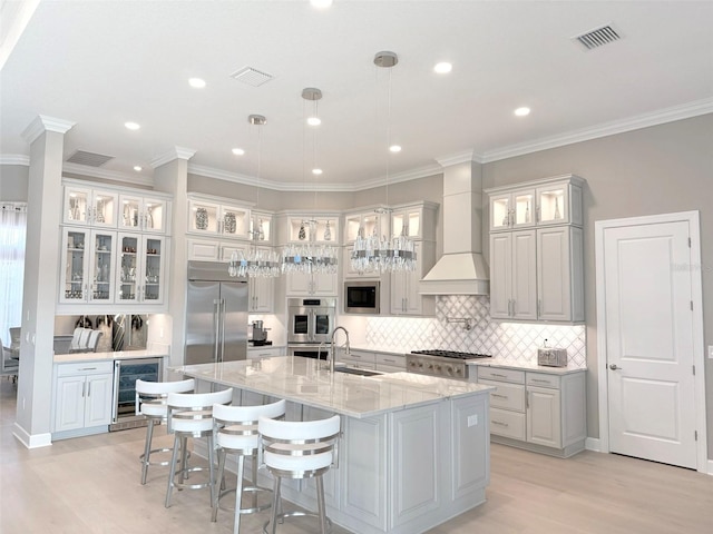 5305 Brookgrove Dr, Sarasota, FL 34238 - kitchen with wine cooler, visible vents, built in appliances, and a sink