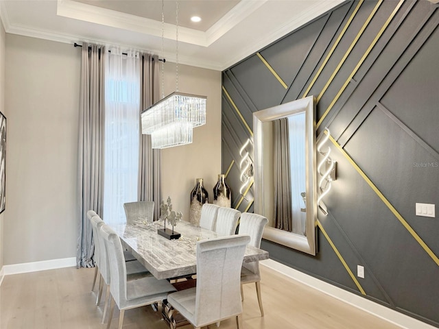 5305 Brookgrove Dr, Sarasota, FL 34238 - dining space with crown molding, baseboards, a chandelier, a tray ceiling, and wood finished floors