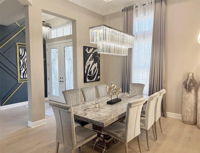 5305 Brookgrove Dr, Sarasota, FL 34238 - dining space with wood finished floors, crown molding, a healthy amount of sunlight, and baseboards