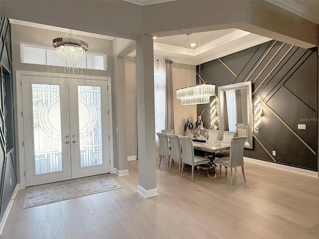 5305 Brookgrove Dr, Sarasota, FL 34238 - entrance foyer with crown molding, baseboards, french doors, an inviting chandelier, and wood finished floors