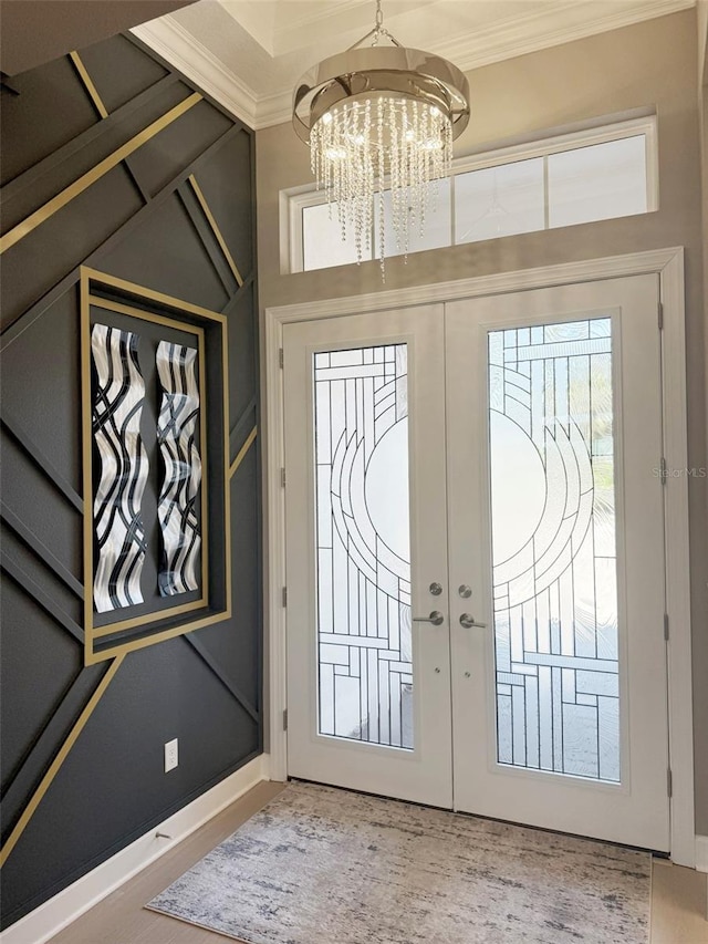 5305 Brookgrove Dr, Sarasota, FL 34238 - foyer with wood finished floors, baseboards, ornamental molding, french doors, and a notable chandelier
