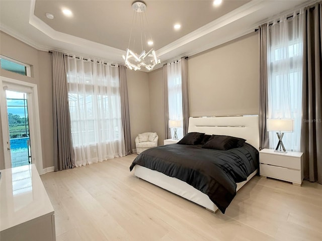 5305 Brookgrove Dr, Sarasota, FL 34238 - bedroom featuring a tray ceiling, multiple windows, a notable chandelier, and access to outside