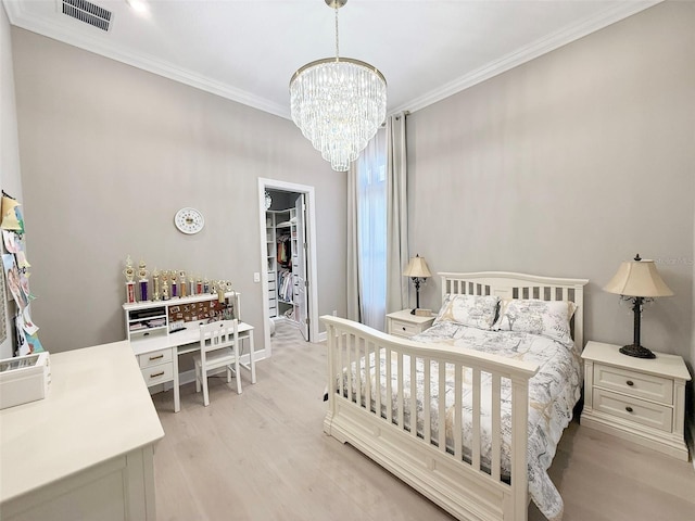 5305 Brookgrove Dr, Sarasota, FL 34238 - bedroom with a notable chandelier, visible vents, light wood-style flooring, and crown molding