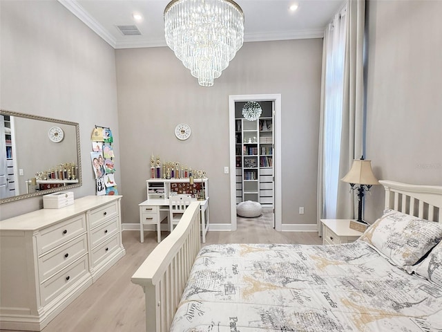 5305 Brookgrove Dr, Sarasota, FL 34238 - bedroom with visible vents, light wood-style floors, crown molding, a chandelier, and a spacious closet