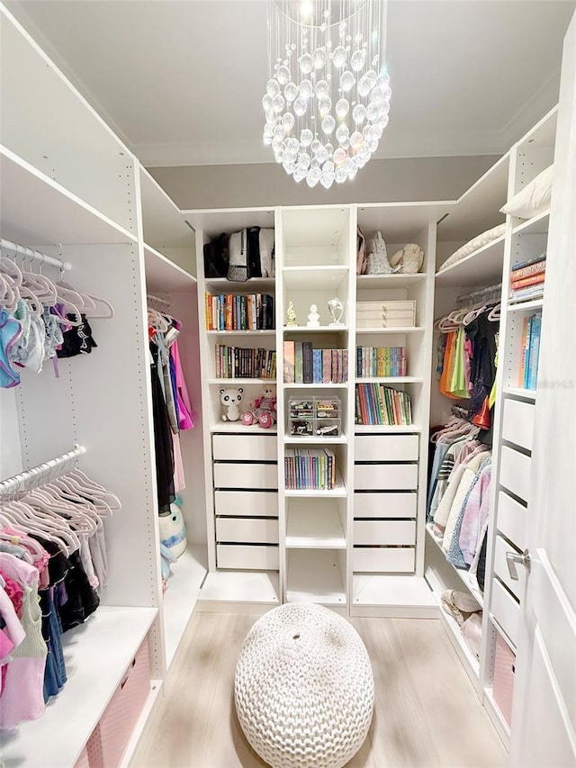 5305 Brookgrove Dr, Sarasota, FL 34238 - spacious closet with a chandelier and wood finished floors
