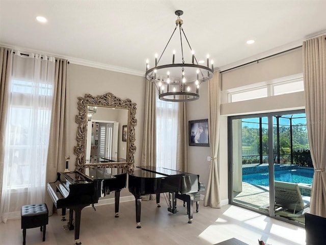 5305 Brookgrove Dr, Sarasota, FL 34238 - living area featuring light wood-style flooring, recessed lighting, crown molding, baseboards, and a chandelier