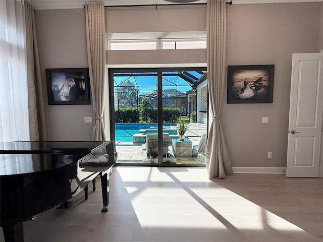 5305 Brookgrove Dr, Sarasota, FL 34238 - interior space with wood finished floors, a pool, baseboards, and a sunroom