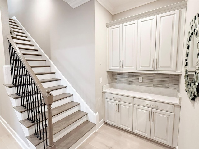 5305 Brookgrove Dr, Sarasota, FL 34238 - stairs with wood finished floors, baseboards, and ornamental molding