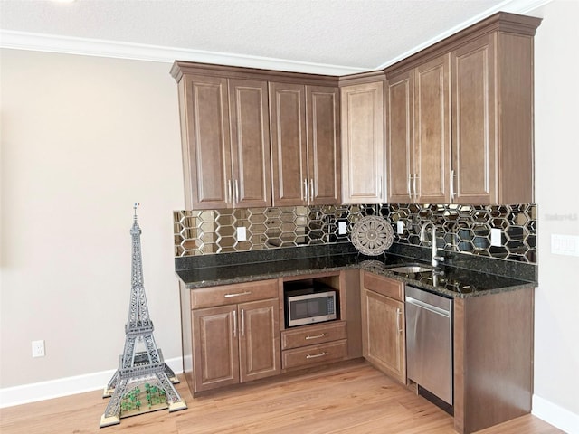 5305 Brookgrove Dr, Sarasota, FL 34238 - kitchen featuring tasteful backsplash, appliances with stainless steel finishes, light wood-style floors, and a sink