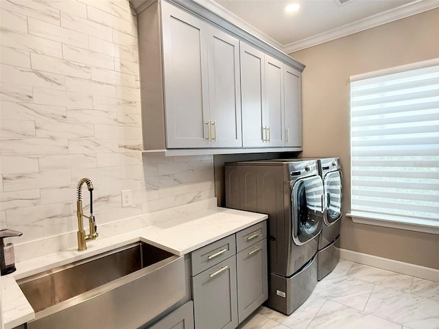 5305 Brookgrove Dr, Sarasota, FL 34238 - clothes washing area with washing machine and clothes dryer, cabinet space, a sink, ornamental molding, and marble finish floor