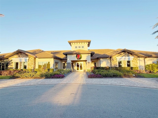 5305 Brookgrove Dr, Sarasota, FL 34238 - view of front of home with a tile roof, stone siding, and stucco siding