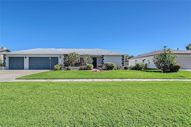 ranch-style house featuring a garage and a front lawn