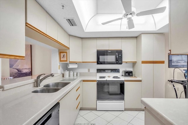 kitchen with ceiling fan, sink, light tile patterned floors, electric range, and dishwasher