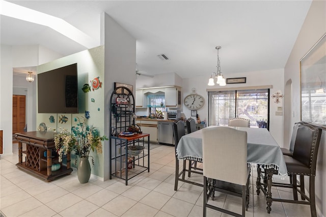 dining area with light tile patterned floors and ceiling fan with notable chandelier