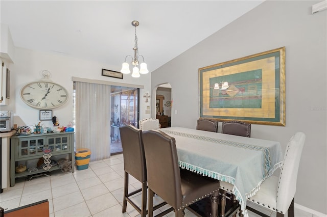 dining room with lofted ceiling, light tile patterned floors, and an inviting chandelier