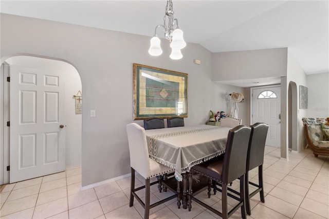 tiled dining space featuring a chandelier