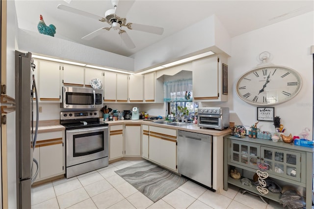 kitchen featuring ceiling fan, appliances with stainless steel finishes, sink, and light tile patterned floors