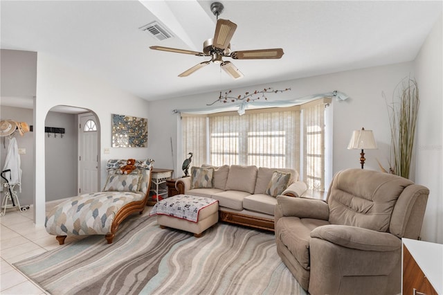 living room featuring light tile patterned floors, vaulted ceiling, and ceiling fan