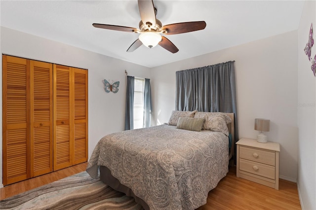 bedroom featuring light hardwood / wood-style floors, a closet, and ceiling fan