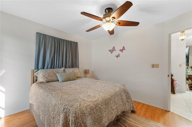 bedroom featuring ceiling fan and light wood-type flooring