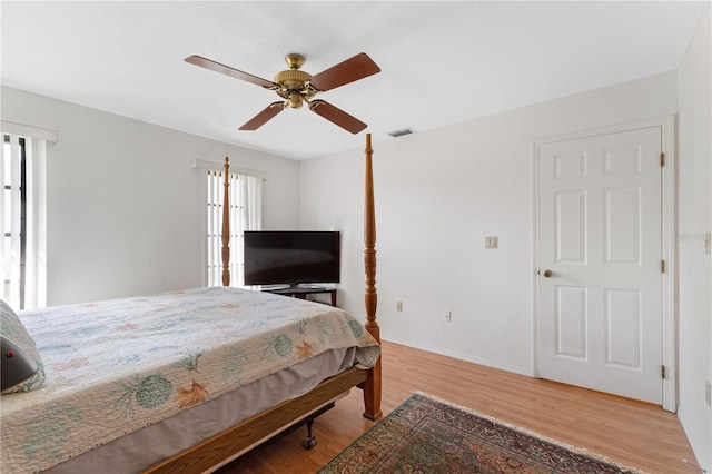 bedroom with hardwood / wood-style flooring and ceiling fan