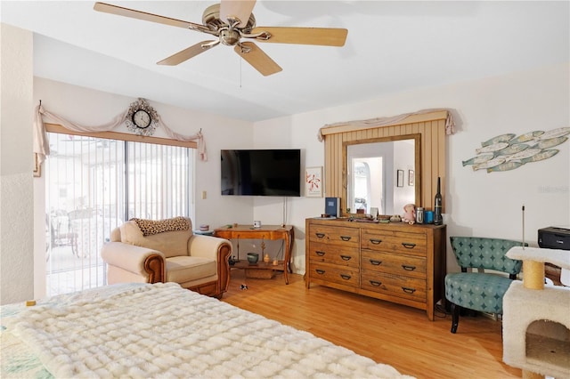 bedroom with hardwood / wood-style floors, ceiling fan, and access to exterior