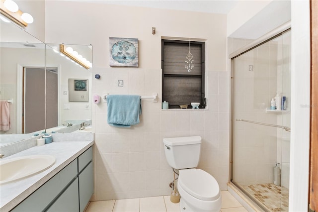 bathroom with an enclosed shower, vanity, tile patterned floors, and toilet