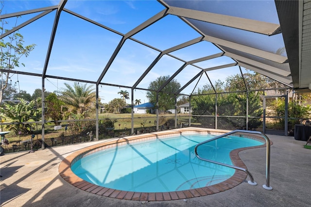 view of swimming pool with a patio and glass enclosure