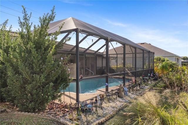 view of pool featuring glass enclosure