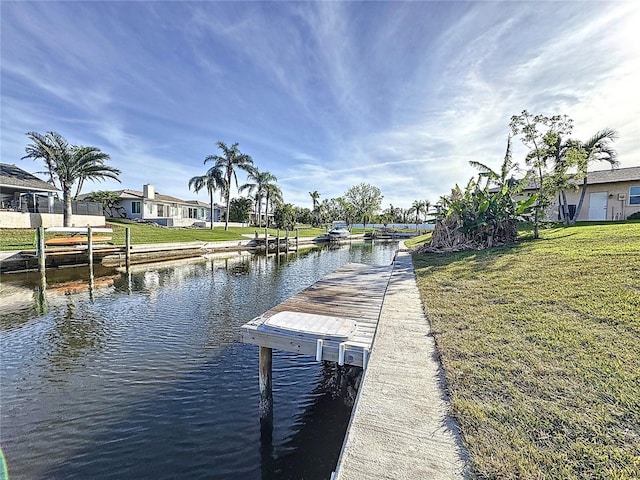 dock area with a yard and a water view