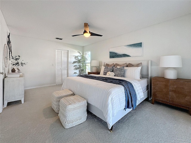 bedroom featuring carpet, ceiling fan, and a closet