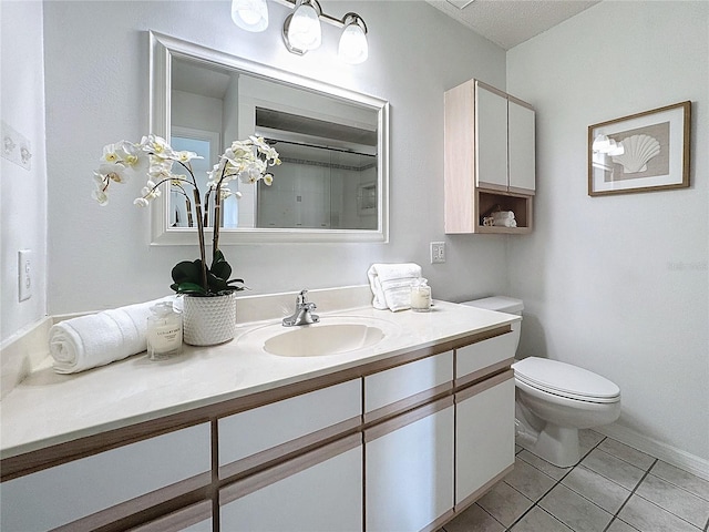 bathroom with tile patterned flooring, vanity, and toilet