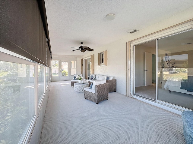 sunroom with ceiling fan