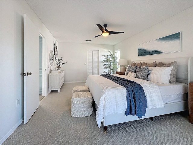 bedroom with ceiling fan, carpet floors, and a closet