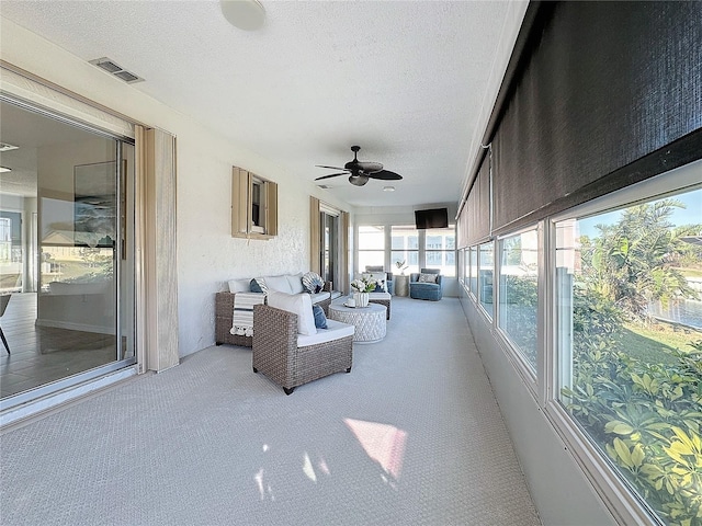 sunroom featuring ceiling fan