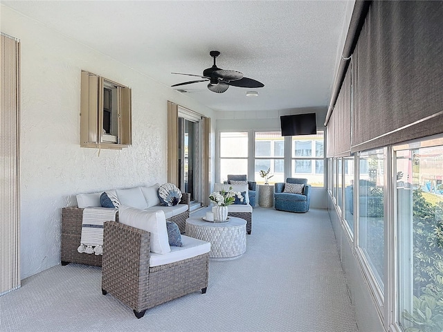 sunroom / solarium featuring ceiling fan