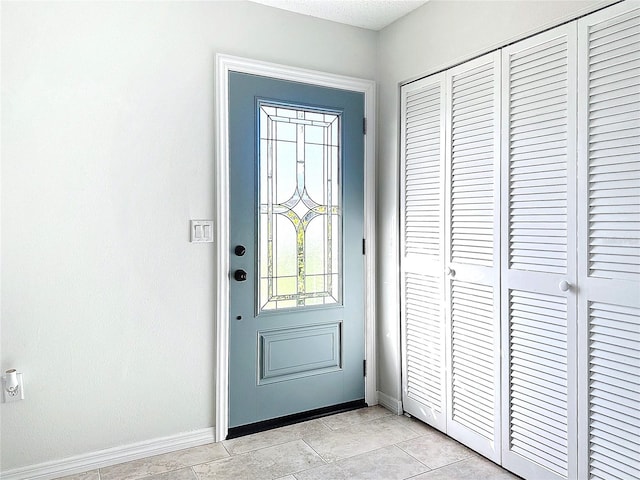 doorway with light tile patterned floors