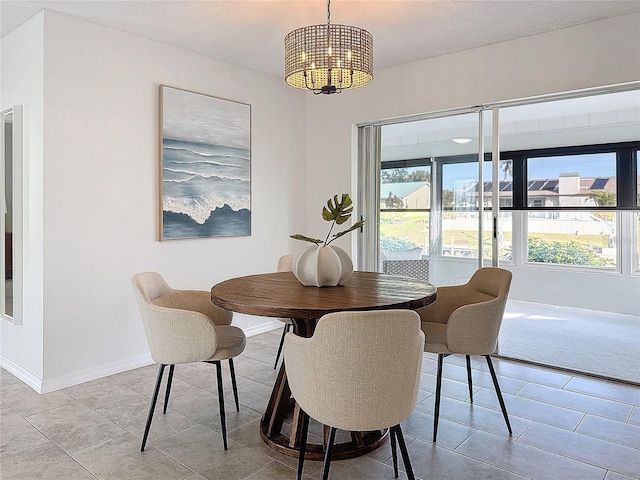 dining room with a textured ceiling and light tile patterned flooring