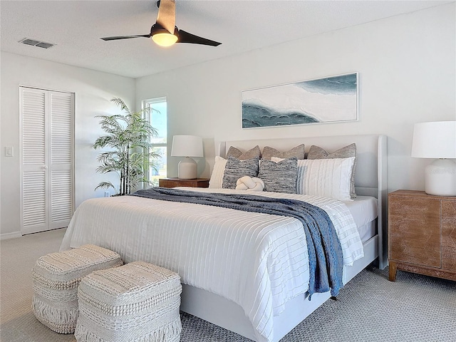 carpeted bedroom with a closet and ceiling fan