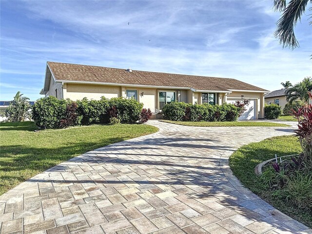 ranch-style home with a garage and a front yard