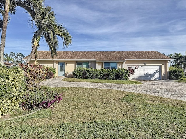 single story home featuring a front lawn and a garage