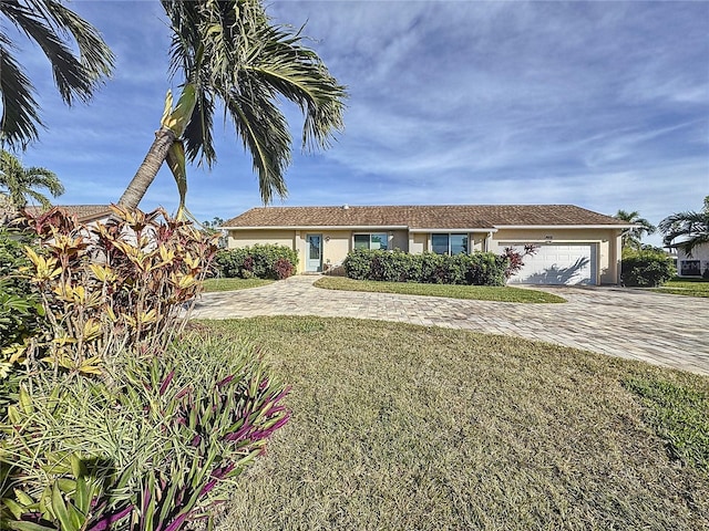 view of front of house with a garage and a front lawn