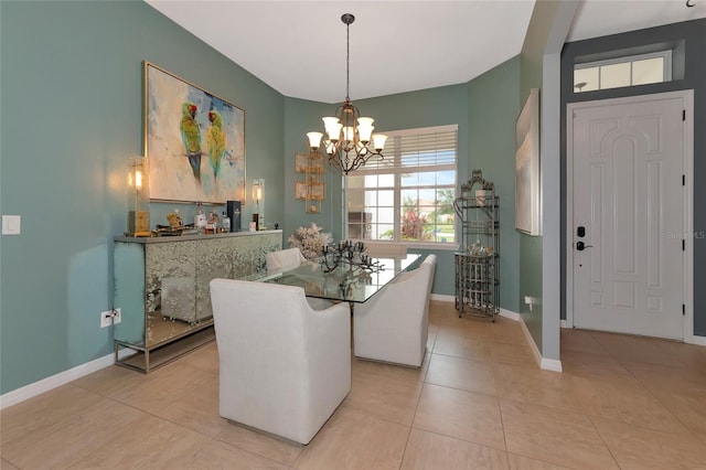 dining space featuring light tile patterned floors and an inviting chandelier