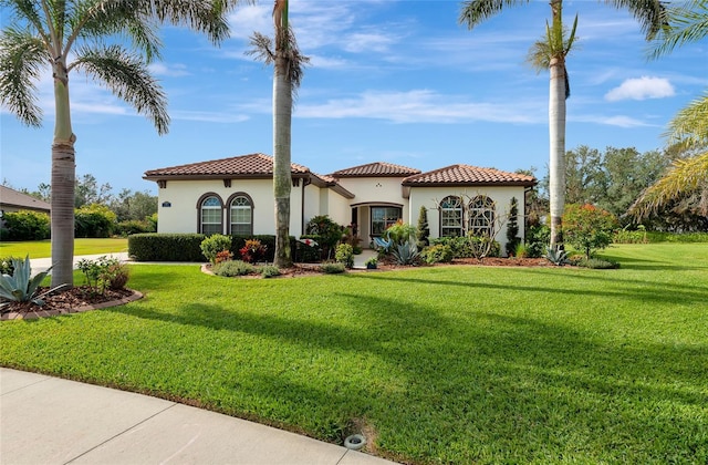 mediterranean / spanish house featuring a front lawn